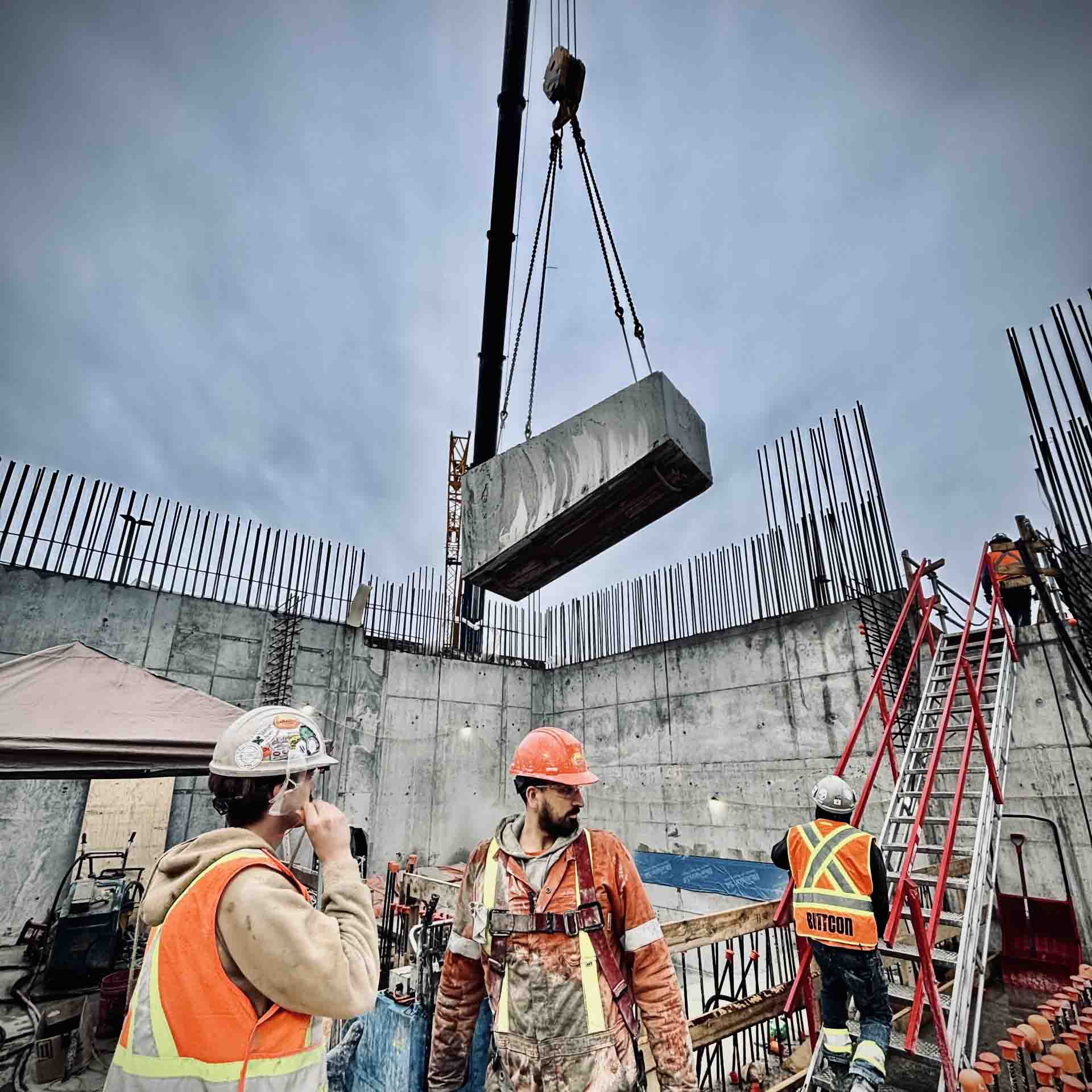 Diamond wire saw rigged with pulleys cutting through a massive concrete section